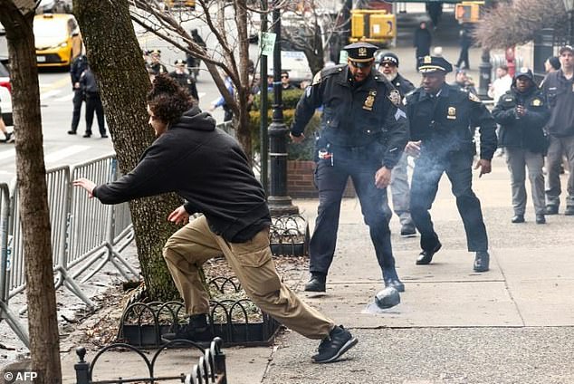 NYPD Officer's Barrier-Leap Becomes Emblem of Heroism in Protest Bomb-Threat Standoff