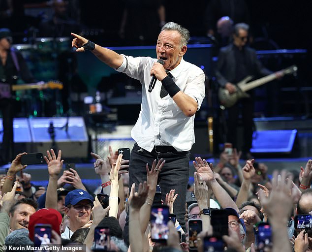 Springsteen walks past Christie at concert, sparking viral snub rumors.